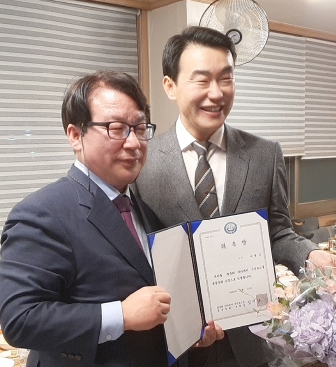 김시천 총회장이 성영모 고문(강남여성병원 병원장)에게 위촉장을 수여하고 있다