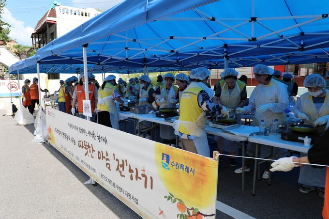 수원시자원봉사센터와 수원FC, 봉사단체 등이 지난 22일 추석맞이 전 나눔 ‘따뜻한 마음 전하기’ 행사에서 전을 부치고 있다.