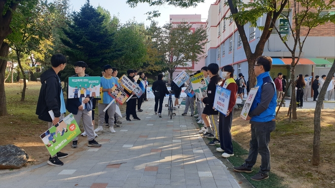 수성중학교 정문에서 학교폭력 예방 캠페인을 실시하고 있다