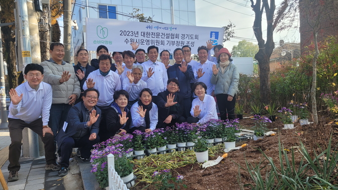 대한전문건설협회 경기도회 수원시운영위원회 회원들이 손바닥정원을 조성하고 있다.