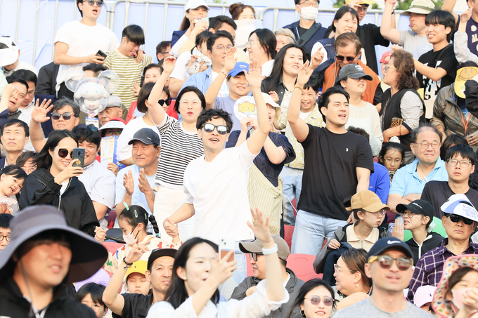 화성 뱃놀이 축제를 찾은 시민들이 열정적으로 공연을 즐기며 환호하고 있다