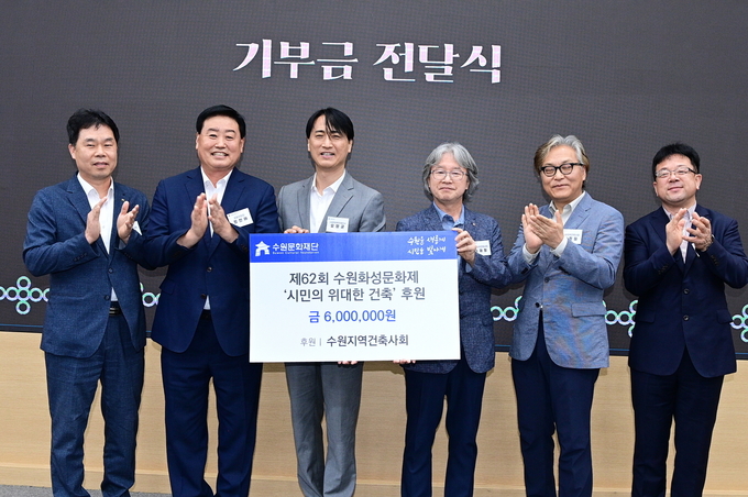 수원지역건축사회가 운영 지원금을 전달하고 있다.