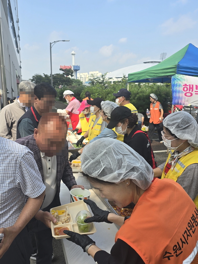 1일 오전 11시 수원종합운동장에서 열린 ‘찾아가는 밥차’에 한국노총과 민주노총 이동노동자들이 참여해 짜장면과 탕수육을 배식받고 있다.